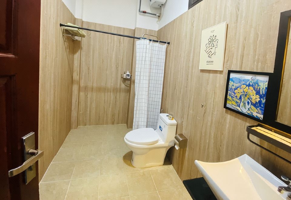 A clean private bathroom with shower, sink and toilet