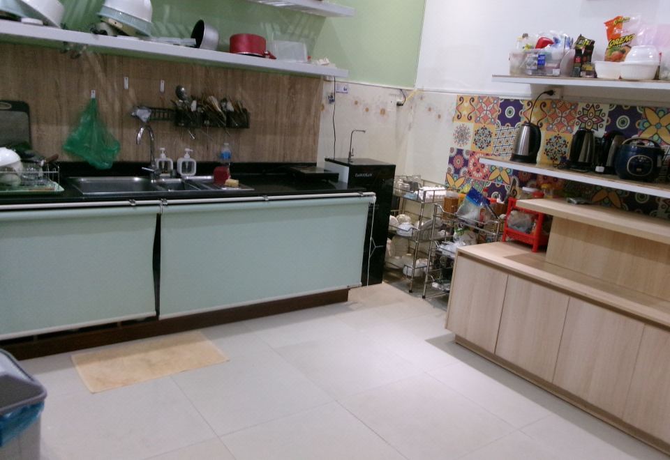 The hostel's shared kitchen with sink, kettle and storage