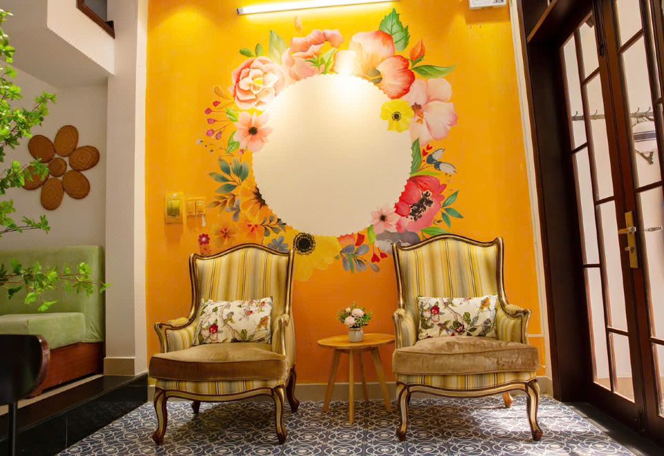 Lobby seating area with a hand-painted floral mural