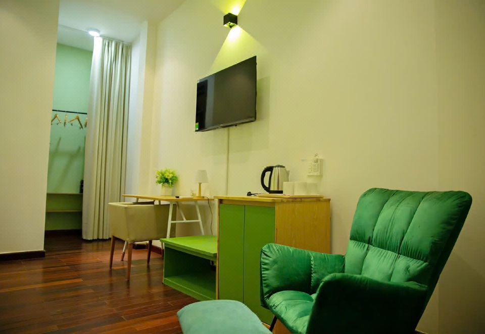 Room corner with TV, electric kettle and an armchair