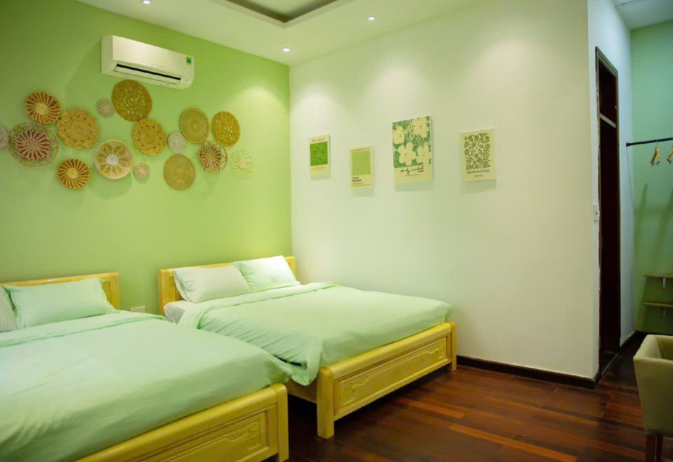 A private room with two beds and woven wall decorations